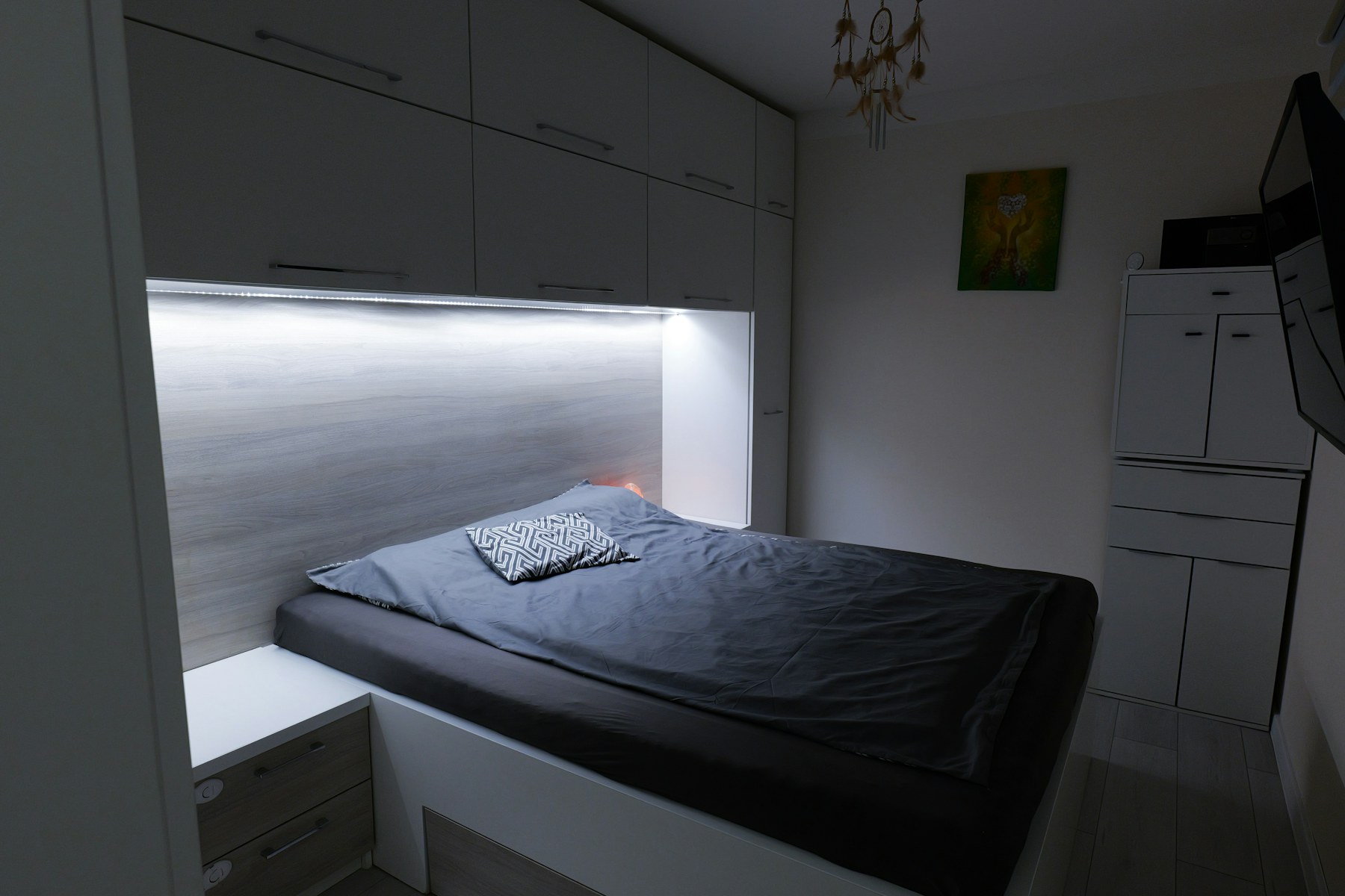 Modern bedroom with integrated joinery and bed